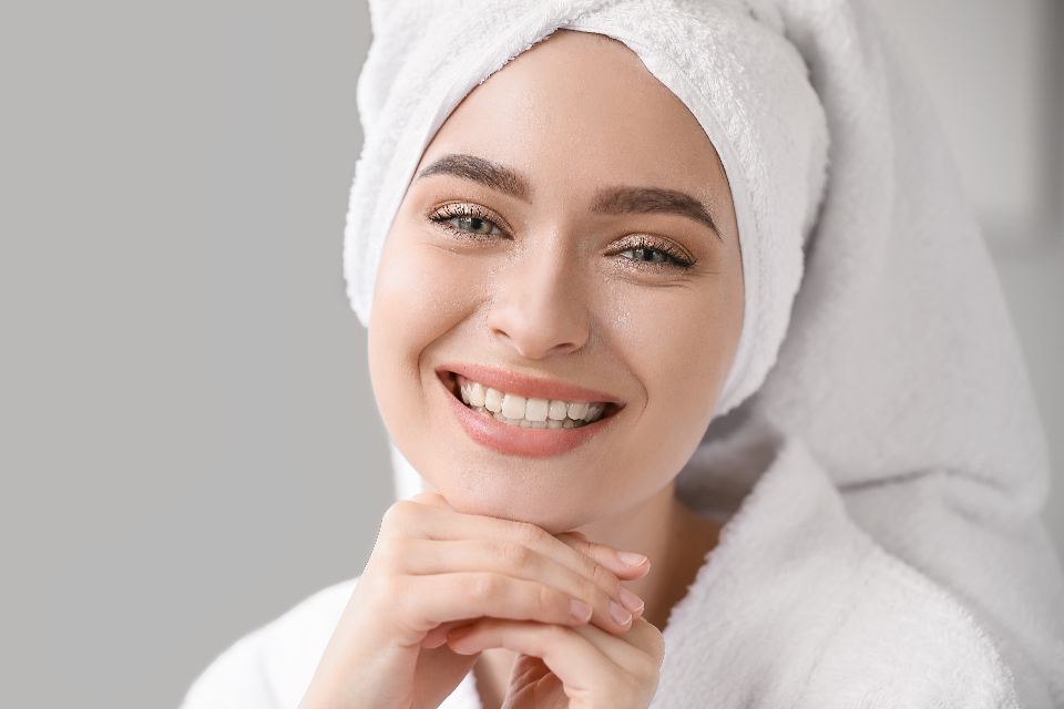 Woman checking her mouth and smile in a mirror